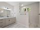 Modern bathroom featuring a double vanity, marble countertops, and a glass-enclosed walk-in shower at 562 Dowling Cir, Lady Lake, FL 32159