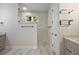Modern bathroom with grey cabinets, marble countertop and backsplash, and glass shower at 562 Dowling Cir, Lady Lake, FL 32159