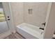 Bright bathroom with white tiled tub and a view outside at 562 Dowling Cir, Lady Lake, FL 32159