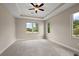 Bright bedroom with a ceiling fan, recessed lighting, large windows offering views of the outdoor landscaping at 562 Dowling Cir, Lady Lake, FL 32159