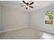 Spacious bedroom with a ceiling fan and large window, bright space at 562 Dowling Cir, Lady Lake, FL 32159