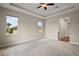 Bright bedroom with a ceiling fan, recessed lighting, large windows offering views of the outdoor landscaping at 562 Dowling Cir, Lady Lake, FL 32159