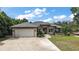 Attractive single Gathering home features a well manicured lawn, a two car garage, and stone accents at 562 Dowling Cir, Lady Lake, FL 32159