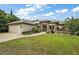 Charming single-story home boasts stone detailing, a two-car garage, and a well-maintained lawn with mature landscaping at 562 Dowling Cir, Lady Lake, FL 32159