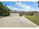 Attractive single-story home featuring stone accents, a two-car garage, and a well-kept front lawn at 562 Dowling Cir, Lady Lake, FL 32159