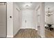 Welcoming foyer with wood floors, neutral paint, coat closet, and an elegant chandelier in the adjacent dining room at 562 Dowling Cir, Lady Lake, FL 32159