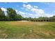 Scenic view of the manicured golf course with lush green grass, mature trees, and a sand trap at 562 Dowling Cir, Lady Lake, FL 32159