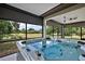 Enjoy the views of the beautiful golf course from the screened-in patio while relaxing in the hot tub at 562 Dowling Cir, Lady Lake, FL 32159