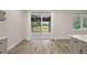 Bright kitchen with white marble countertops, pendant lights, and an exterior view at 562 Dowling Cir, Lady Lake, FL 32159