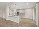 Modern kitchen with a center island, pendant lighting, stainless steel appliances, and white cabinets for a sleek look at 562 Dowling Cir, Lady Lake, FL 32159
