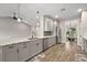Bright kitchen with stainless steel appliances, marble countertops, modern fixtures, and a view into the dining area at 562 Dowling Cir, Lady Lake, FL 32159