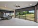 Relaxing screened-in lanai with a hot tub, offering views of the lush green backyard and mature trees at 562 Dowling Cir, Lady Lake, FL 32159