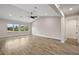 Spacious living room boasts vaulted ceilings, abundant natural light, and wood flooring for a bright, airy ambiance at 562 Dowling Cir, Lady Lake, FL 32159