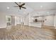 Spacious living room showcasing an open floor plan, modern kitchen, and stylish barn door access to other rooms at 562 Dowling Cir, Lady Lake, FL 32159