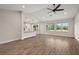 Open floor plan with wood flooring, kitchen island, and views of the outdoor scenery through large windows at 562 Dowling Cir, Lady Lake, FL 32159