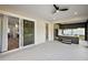 Relaxing screened-in patio features a modern ceiling fan, hot tub, and sliding door access to the home's interior at 562 Dowling Cir, Lady Lake, FL 32159
