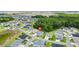 Aerial view of a community with lush greenery and mature trees, pinpoints the location of a charming home at 6988 Lawrenceville Way, The Villages, FL 34762