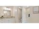Bright bathroom with granite countertops and cabinetry at 6988 Lawrenceville Way, The Villages, FL 34762