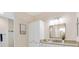 Bathroom features double sink vanity and granite countertops at 6988 Lawrenceville Way, The Villages, FL 34762