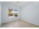 Bright bedroom with tile floors and window overlooking the pool area at 6988 Lawrenceville Way, The Villages, FL 34762