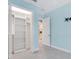 Bedroom features walk in closet, cool tone paint, and tile flooring at 6988 Lawrenceville Way, The Villages, FL 34762