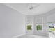 This bedroom features a bay window and tile floors with neutral colors at 6988 Lawrenceville Way, The Villages, FL 34762