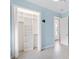 Well-organized closet with built-in shelving and hanging rods, connecting to a tile-floored bedroom and hallway at 6988 Lawrenceville Way, The Villages, FL 34762
