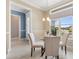 Cozy dining area with natural light from a large window and comfortable seating at 6988 Lawrenceville Way, The Villages, FL 34762