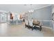 Open dining area with views of the kitchen and bar, featuring a modern light fixture at 6988 Lawrenceville Way, The Villages, FL 34762