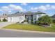 Beautifully landscaped single-story home with a three-car garage and a well-maintained lawn at 6988 Lawrenceville Way, The Villages, FL 34762