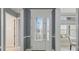 Elegant front door with decorative glass, white trim, and sidelights adding character to the entryway at 6988 Lawrenceville Way, The Villages, FL 34762