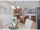 A kitchen with stainless steel appliances and an island that's open to the breakfast nook at 6988 Lawrenceville Way, The Villages, FL 34762