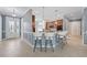 A kitchen with an island that has a bar for seating and is open to the entry hall at 6988 Lawrenceville Way, The Villages, FL 34762