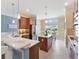 Well-lit kitchen with island, stainless appliances, and adjacent dining area at 6988 Lawrenceville Way, The Villages, FL 34762
