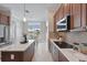 A kitchen with stainless steel appliances, tiled backsplash and breakfast nook at 6988 Lawrenceville Way, The Villages, FL 34762