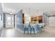 Open concept kitchen with breakfast bar, pendant lights, and tile floors at 6988 Lawrenceville Way, The Villages, FL 34762