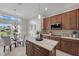 A kitchen with stainless steel appliances, an island, and a breakfast nook at 6988 Lawrenceville Way, The Villages, FL 34762