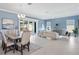 Open-concept living space with dining area and access to the lanai and pool at 6988 Lawrenceville Way, The Villages, FL 34762