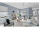 Comfortable living room with contemporary furnishings, tile floors, and plenty of natural light at 6988 Lawrenceville Way, The Villages, FL 34762