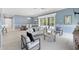Expansive open-concept living area with multiple seating areas and outdoor views at 6988 Lawrenceville Way, The Villages, FL 34762