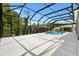 Backyard view showcasing a screened-in pool and patio, perfect for enjoying outdoor relaxation and privacy at 6988 Lawrenceville Way, The Villages, FL 34762