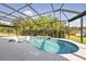 Inviting screened-in pool offers privacy and a relaxing atmosphere, enhanced by natural light and refreshing clear water at 6988 Lawrenceville Way, The Villages, FL 34762