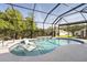 Beautiful pool with seating, set within a screened enclosure, providing a private and comfortable outdoor experience at 6988 Lawrenceville Way, The Villages, FL 34762