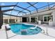 Inviting screened-in pool area with lounge chairs and an outdoor bar, great for relaxing and entertaining at 6988 Lawrenceville Way, The Villages, FL 34762
