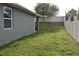 Side view of the backyard featuring green grass and a white vinyl privacy fence at 709 Calabria Way, Howey In The Hills, FL 34737