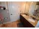 Bathroom featuring double sinks with granite countertops and a decorative mirror at 709 Calabria Way, Howey In The Hills, FL 34737