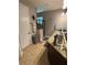 Modern bathroom with granite countertops, double sinks, and a glass-enclosed shower at 709 Calabria Way, Howey In The Hills, FL 34737