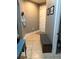 Well-lit entryway featuring a bench and tile flooring, providing a functional and stylish welcome at 709 Calabria Way, Howey In The Hills, FL 34737