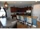Spacious kitchen with granite countertops, stainless steel appliances, and a breakfast bar at 709 Calabria Way, Howey In The Hills, FL 34737