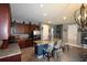 Open-concept kitchen with granite countertops, stainless steel appliances, and a breakfast bar at 709 Calabria Way, Howey In The Hills, FL 34737